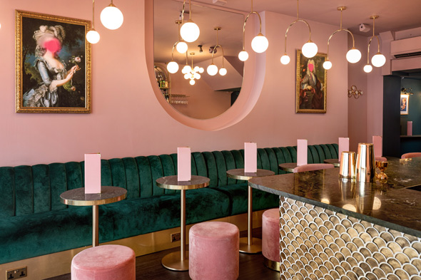 R Place Cocktail Bar interior with pink and green velvet accessories and gold retro lighting and bar